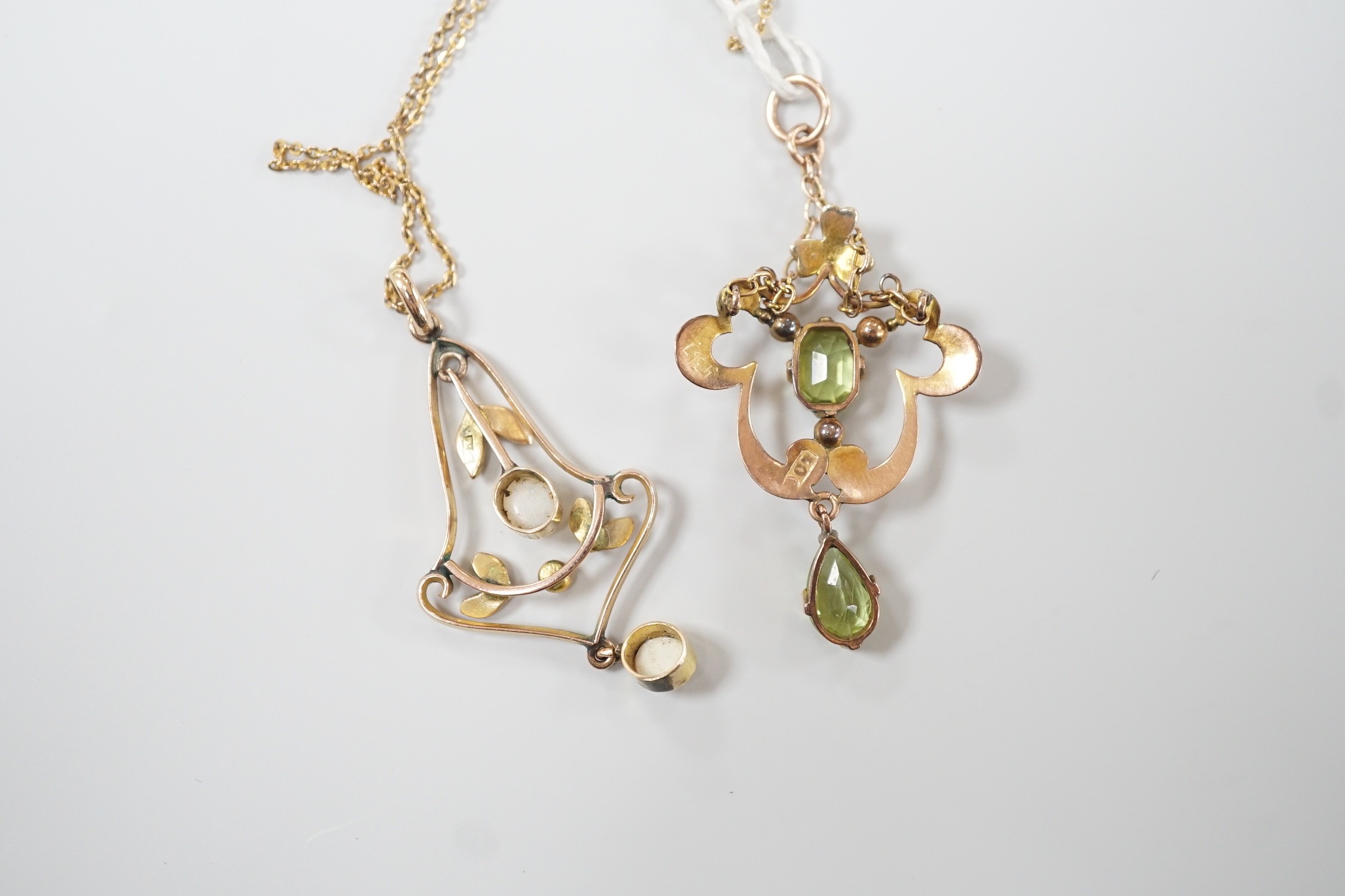 An early 290th century 9ct, peridot and seed pearl set drop pendant, overall 44mm and a similar yellow metal, white opal and seed pearl pendant on a 9ct chain, gross weight 6.4 grams.